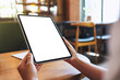 © Farknot Architect - Mockup image of a woman holding digital tablet with blank white desktop screen