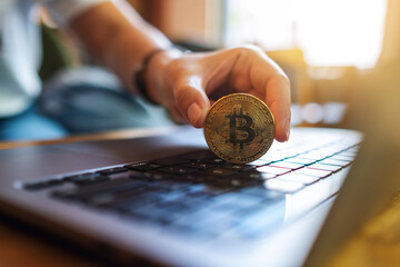 Poster - People holding and showing bitcoin on laptop computer