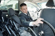© pressmaster - Disabled businessman in suit putting wheel of folded wheelchair in his car before driving