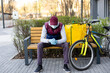© Angelov - Young delivery man with yellow backpack takeaway concept
