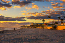 Coast Of Daytona Beach In Florida At Sunrise With People And Palm Trees