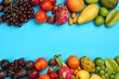Assortment of fresh exotic fruits on light blue background, flat lay. Space for text