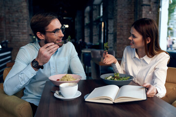 Wall Mural - business man and woman breakfast in a cafe communication work colleagues