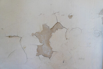 old textured wall with paint peeling of it