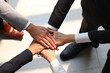 © Stella - Overhead view of businessman and woman putting hands join together, business partnership colleagues holding hands as commitment of strong team work, unity and teamwork Join hands support concept