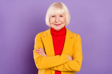 Sticker - Photo of cheerful pretty short hairdo aged lady crossed arms wear yellow jacket isolated on purple color background