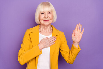 Poster - Photo of cheerful nice short hairdo elder lady pray wear yellow jacket isolated on purple color background