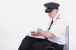 © Monika Wisniewska - Airline captain pilot fills out the paperwork before the flight