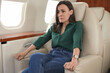 © New Africa - Nervous young woman suffering from aviophobia in airplane