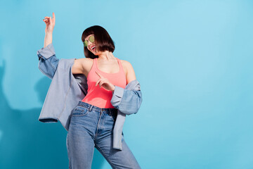 Poster - Portrait of attractive cheerful girl dancing moving having fun copy empty space isolated over bright blue color background