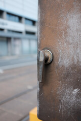 Sticker - Vertical shot of an old handle on a metal door under the sunlight