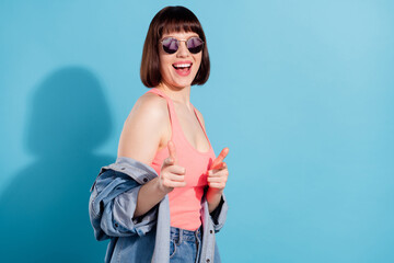 Canvas Print - Photo of sweet pretty woman wear denim shirt dark eyewear pointing fingers you empty space smiling isolated blue color background