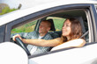 © JackF - Positive elegant couple of tourists woman and man sitting in car while traveling together