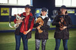 © Svitlana - Three professional dog handlers posing for the camera