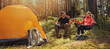 © ronstik - forest camping - young hiker couple enjoying cup of tee at campsite