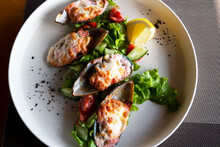 Seafood. Clams From Mussels. Baked Mussels In A Green Shell With Cheese, Lettuce And Lemon