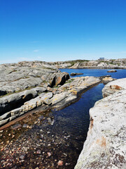 Sticker - Scenic shot of a sea surrounded by stone mountains in Verdens Ende, Norway