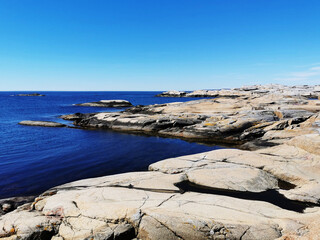 Sticker - Scenic shot of a sea surrounded by stone mountains in Verdens Ende, Norway