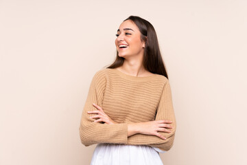 Young caucasian woman isolated on beige background happy and smiling