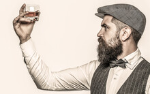 Bearded Gentleman Drink Cognac. Sipping Finest Whiskey. Portrait Of Man With Thick Beard. Macho Drinking