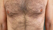 A man with a hairy male breast close-up. Long chest hair