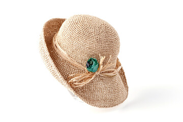 Beautiful straw hat, beautiful with a ribbon and bow on the beach hat, white background.Concept of fashion clothing accessories and beach holidays.Texture of summer straw hat from interwoven raffia.