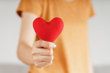 Wall Mural -  Woman holding red heart, love, health insurance, donation, happy charity volunteer, world mental health day, world heart day, valentine's day