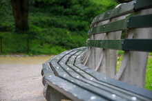 Curved Green Wooden Bench In A Park In The Summer