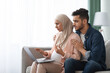 © Prostock-studio - Portrait Of Confused Pregnant Muslim Couple Looking At Laptop Screen At Home