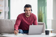 © Prostock-studio - Happy arab guy attending online training from home
