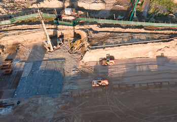 Poster - Vibration road roller and wheel loader leveling ground for construct of foundation. Soil Compactor compresses soil under the formwork. Dozer at construction site. Soft focus