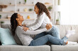 © Prostock-studio - Loving black mother and kid bonding while relaxing on couch