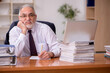 © Elnur - Old male employer and too much work in the office