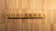 The word gonorrhea created from wooden cubes. Health and life