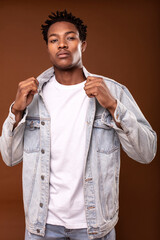 Wall Mural - Handsome african american man  wearing casual jeans jacket, posing in studio.