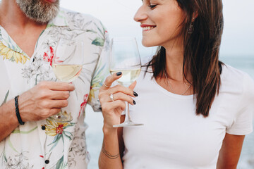 Couple enjoying a glass of wine by the beach