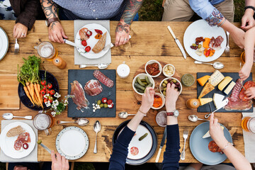 Wall Mural - Aerial view of people having dinner in the backyard