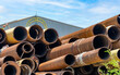 Pile of old rusty round metal industrial pipe. Steel pipe stack at warehouse of factory. Industrial material. Metal corrosion. Stack of rusty tube. Old iron pipe at warehouse. Metal pipe industry.