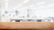 Empty wood table top and blur modern office space building background - can used for display or montage your products.