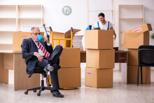 Old Businessman And Young Contractor In Relocation Concept