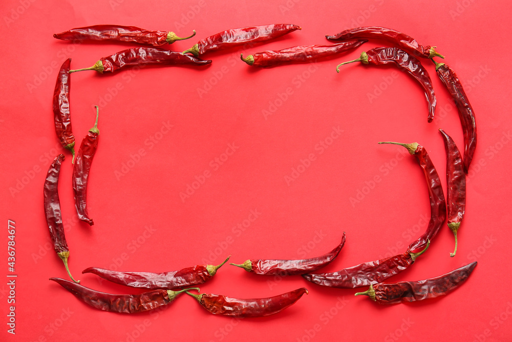 Frame made of hot chili peppers on color background