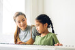 © Art_Photo - Portrait of enjoy happy love asian family mother and little asian girl child smiling and having fun teaching and play piano music lesson at home
