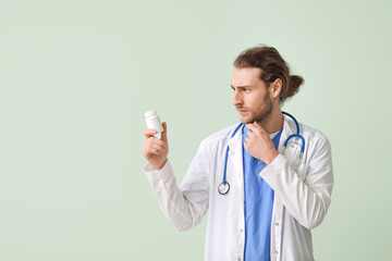 Wall Mural - Thinking doctor with pills on color background