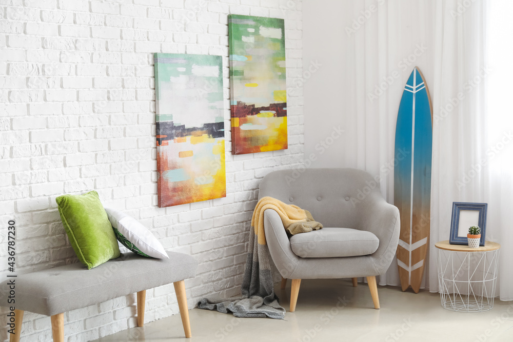 Surfboard with armchair in interior of room