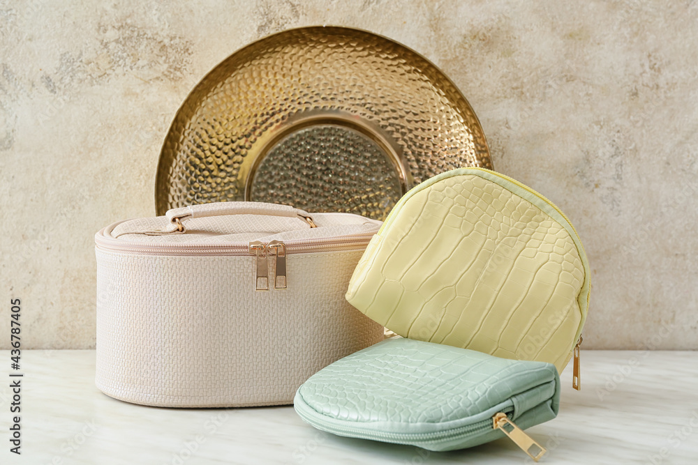 Cosmetic bags on light background