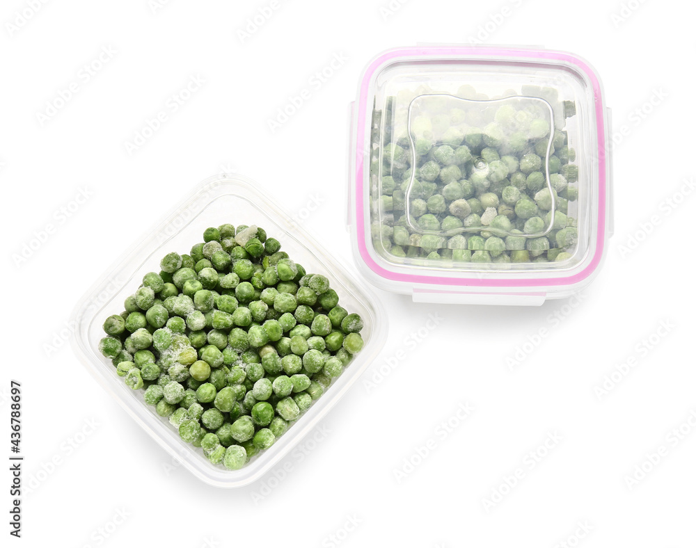 Plastic containers with frozen green peas on white background