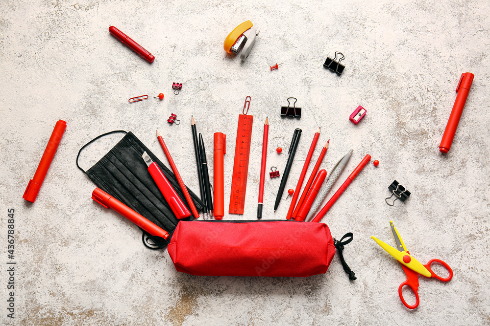 Pencil case with set of stationery on light background