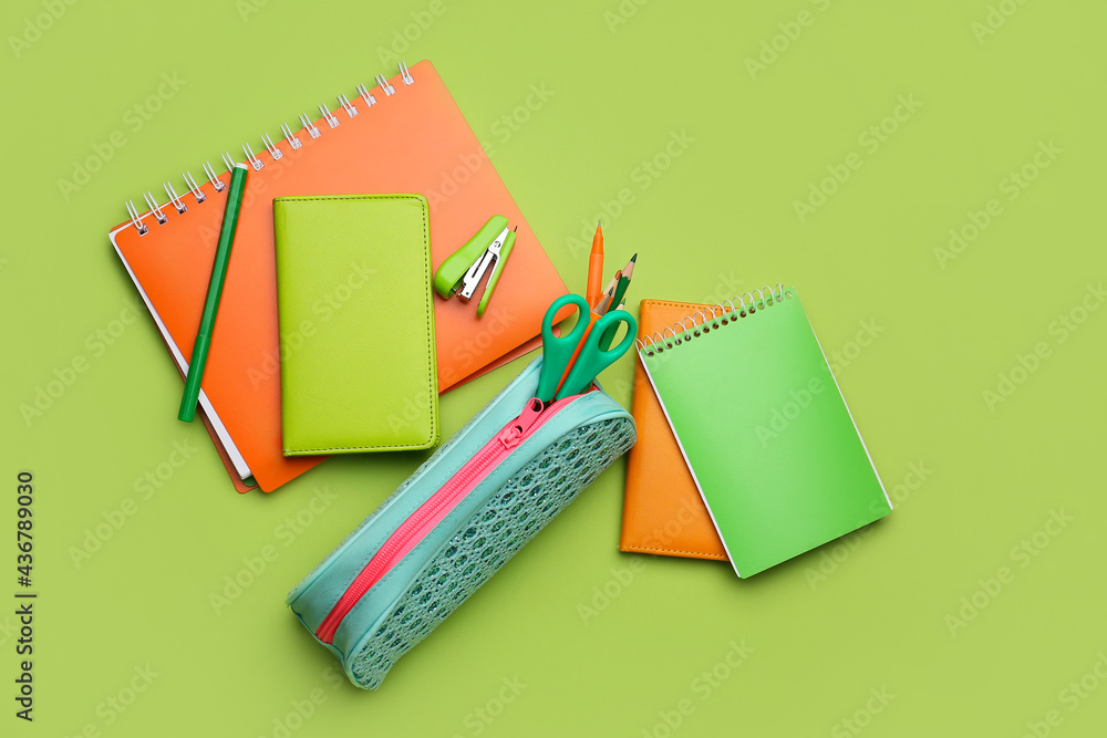 Pencil case and stationery on color background - obrazy, fototapety, plakaty 
