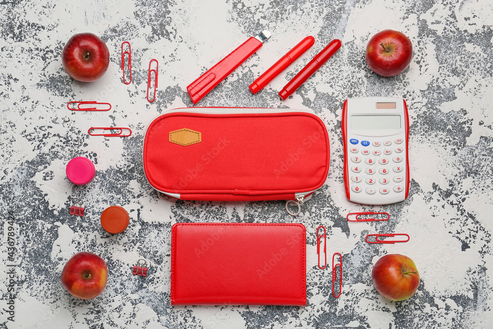 Pencil case and stationery on grunge background