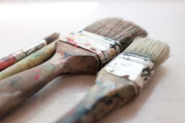 Set of colorful, used brushes full of paint. Intentional selective Focus!